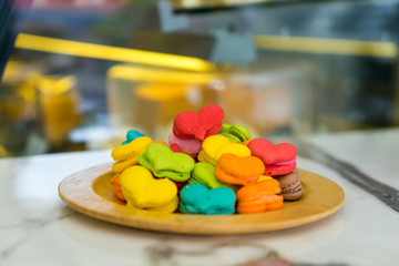 stack of macaron heart shape dessert  on woodent plate