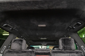 The ceiling of the SUV car pulled by black soft material alkantara in the workshop for tuning and...