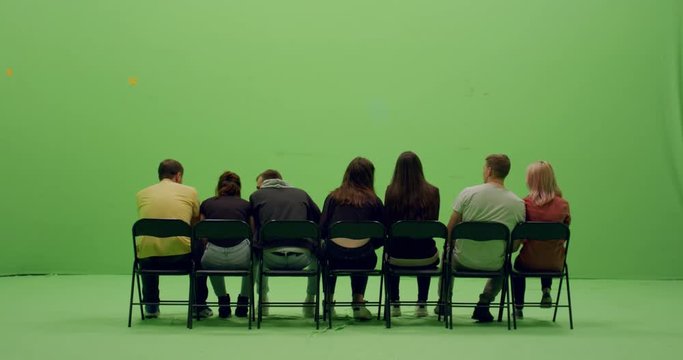 GREEN SCREEN CHROMA KEY Back view group of young people watching and cheering at a sport event. 4K UHD ProRes 4444