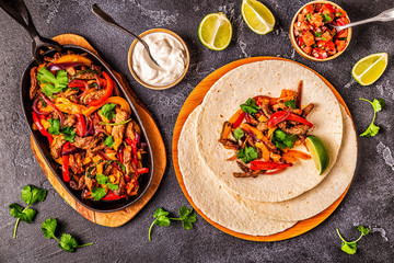 FAJITAS with colored pepper and onions, served with tortillas. - obrazy, fototapety, plakaty