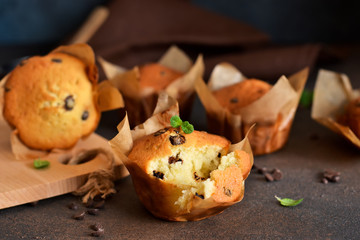 Muffins with chocolate chunks on the kitchen table with space for text. View from above