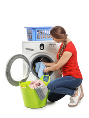 Young woman doing laundry on white background