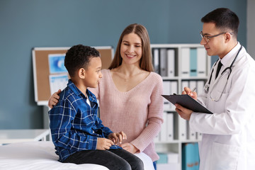 African-American boy with mother at pediatrician's office © Pixel-Shot