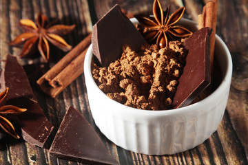 Cocoa powder and a bar of dark chocolate