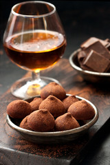Chocolate truffles on wooden board. Atmospheric food photo