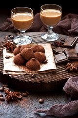  Sweet chocolate candy with liqueur in glass, dessert table