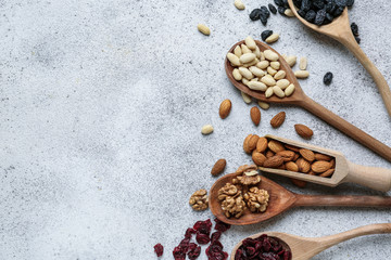 Assortment of tasty dried fruits and nuts on grey background