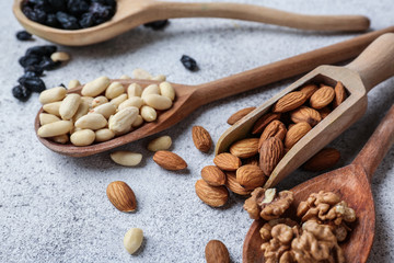 Assortment of tasty nuts on grey background