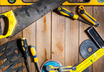 Working tools on wooden rustic background.