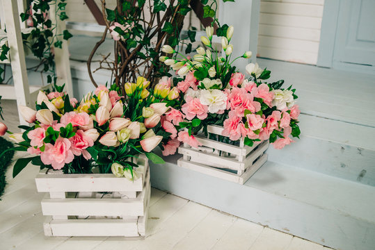 boxes with blooming flowers on the threshold of the house, decoration for a photo studio