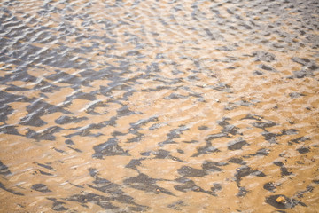 River sand. Texture of sand under water. Yellow fine sand and water texture. The best background for tourism. Sand under water on a black background. Clean and fresh spring water.