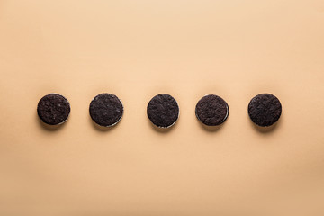 Tasty chocolate cookies on color background