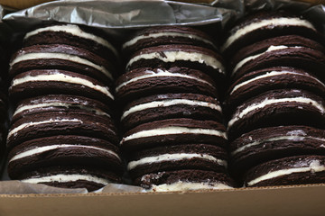Box with tasty chocolate cookies, closeup