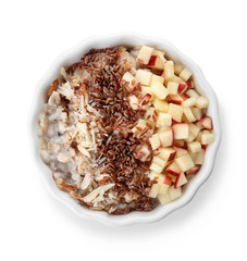 Bowl with tasty sweet oatmeal on white background