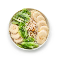 Bowl with tasty sweet oatmeal on white background