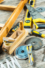 Working tools on wooden rustic background.