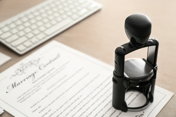 Marriage contract and stamp on table of notary public