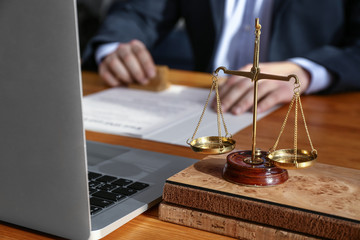 Scales of justice on table of notary public