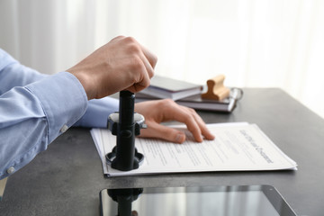 Notary public stamping document in office