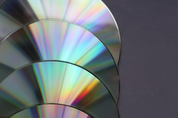 Shiny compact disks on dark background, closeup