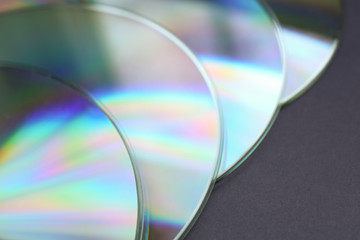 Shiny compact disks on dark background, closeup