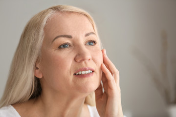 Mature woman with healthy skin at home