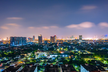 Fototapeta na wymiar Cityscape from high rise building at night with skyline and clouds. skyscraper in metropolis town with beautiful neon light Bangkok Thailand.