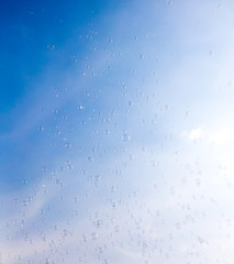 Soap bubbles fly in the blue sky