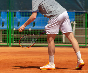 Fototapeta na wymiar A man plays tennis on the court in the park