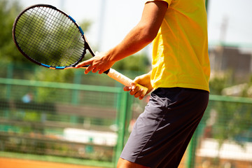 A man plays tennis on the court in the park