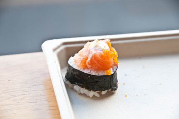 Golden orange fresh tasty raw Japanese salmon belly with cream and a hint of tiny shrimp eggs top up on sticky white rice wrapped with crispy seaweed