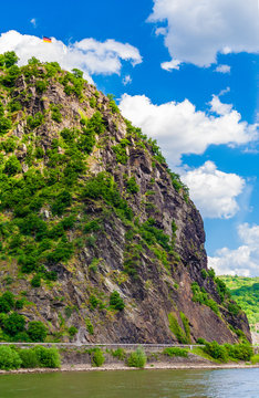 Beautiful view of the Lorelei (German: Loreley), a steep slate rock on the Rhine riverbank in the Rhine Gorge, a UNESCO World Heritage Site, at St. Goarshausen on a nice sunny day with blue sky. 