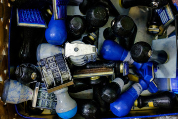 Many rubber stamps are put together in a basket. Is a Thai rubber stamp and shows the Thai language date and year