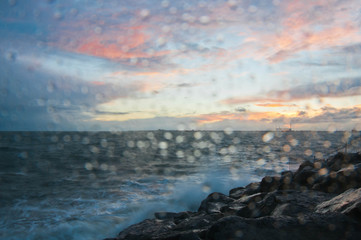 Fototapeta premium Dramatic splashing ocean wave in the evening with twilight sky in Winter at breakwater at St Kilda pier in Melbourne Australia