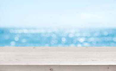 Fototapeta premium Blurred sea background with wood resort deck floor foreground