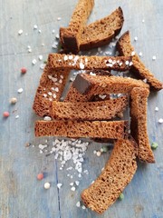 Toasted rye crouton bread with spices on a vintage wood texture