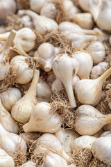 A full frame photograph of garlic bulbs for sale at a farmers market