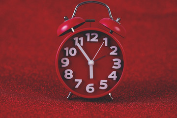 Red background image and beautiful red alarm clock Concept, time, date