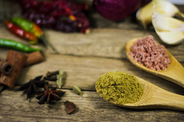 Close up of various asian spices and common ingredients on wooden board. Selective focus.