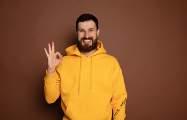 Obraz premium Image of positive bearded man laughing and showing ok sign