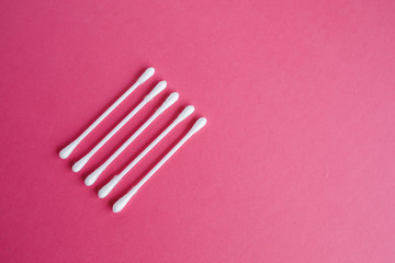 Cotton buds isolated on ping background.
