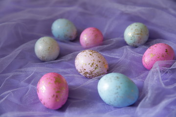 Colorful Easter eggs in purple fabric . Easter background.