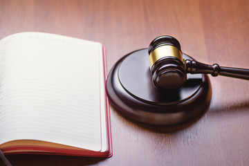 Book, judge's gavel, criminal codex on the judge's table. Concept of law and order. Table of the judge.