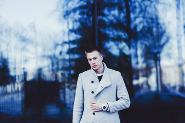 portrait of a fashion model with copy space, man wearing coat and watch