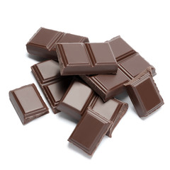 Dark organic chocolate pieces isolated on white background