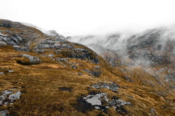 Scenic view of the norwegian mountains and a lake on Lofoten Islands on a rainy day