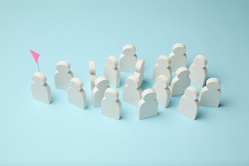 The best employee in the team. Competition, selection for the position. White figures of people on a blue background, business concept.
