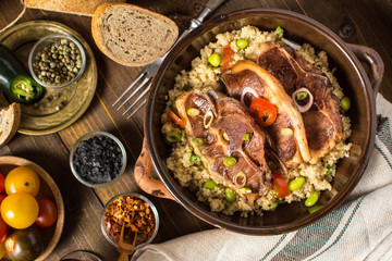 Homemade Roasted Lamb Loin Chops with Couscous and Soybean in Rustic Clay Dish