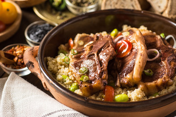 Homemade Roasted Lamb Loin Chops with Couscous and Soybean in Rustic Clay Dish