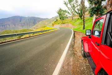 Red summer car on road in Gran Canaria island 